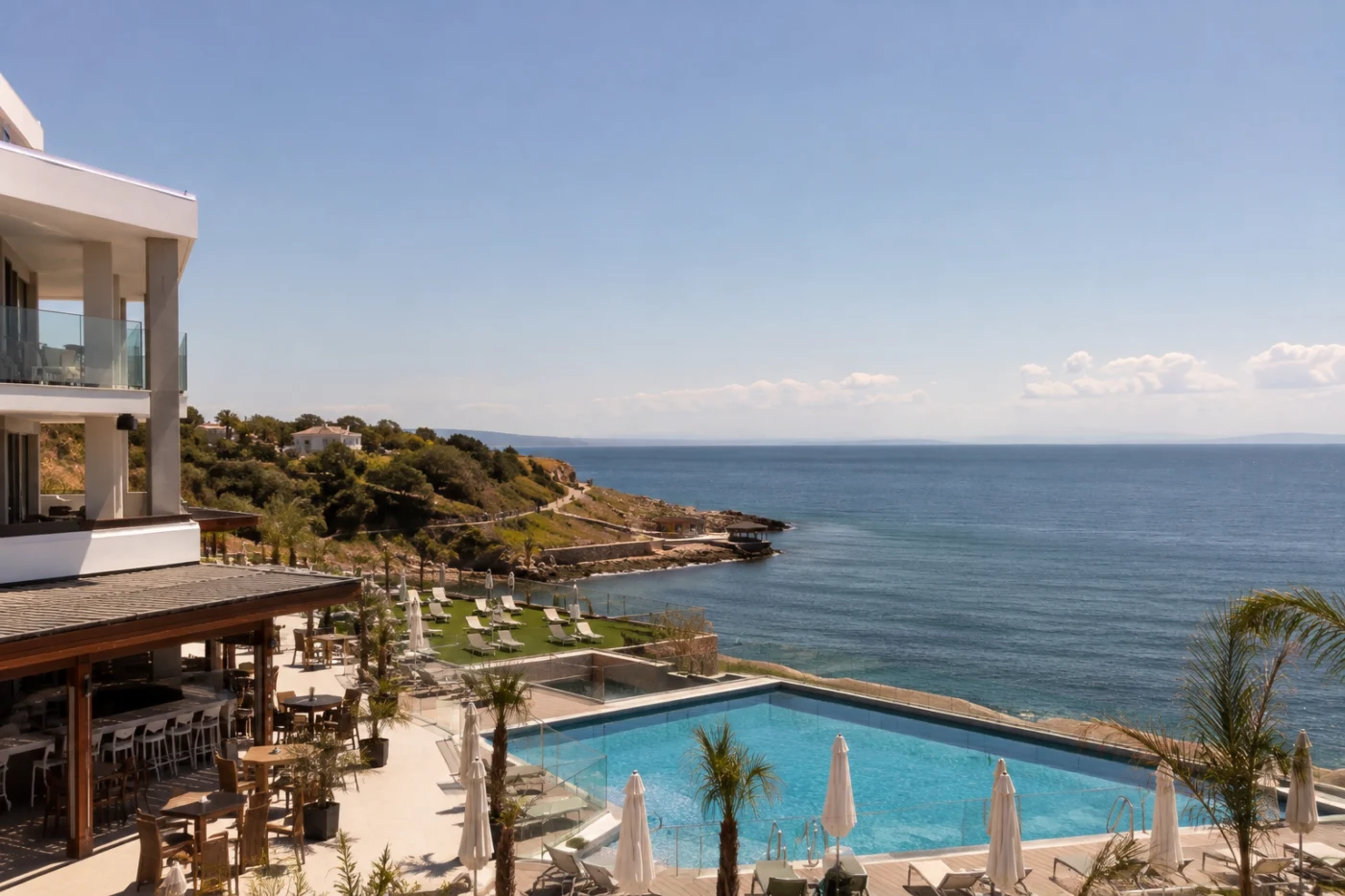 Modern all-inclusive resort with swimming pool and terrace on a lush Mediterranean coast in spring, during the Easter holidays