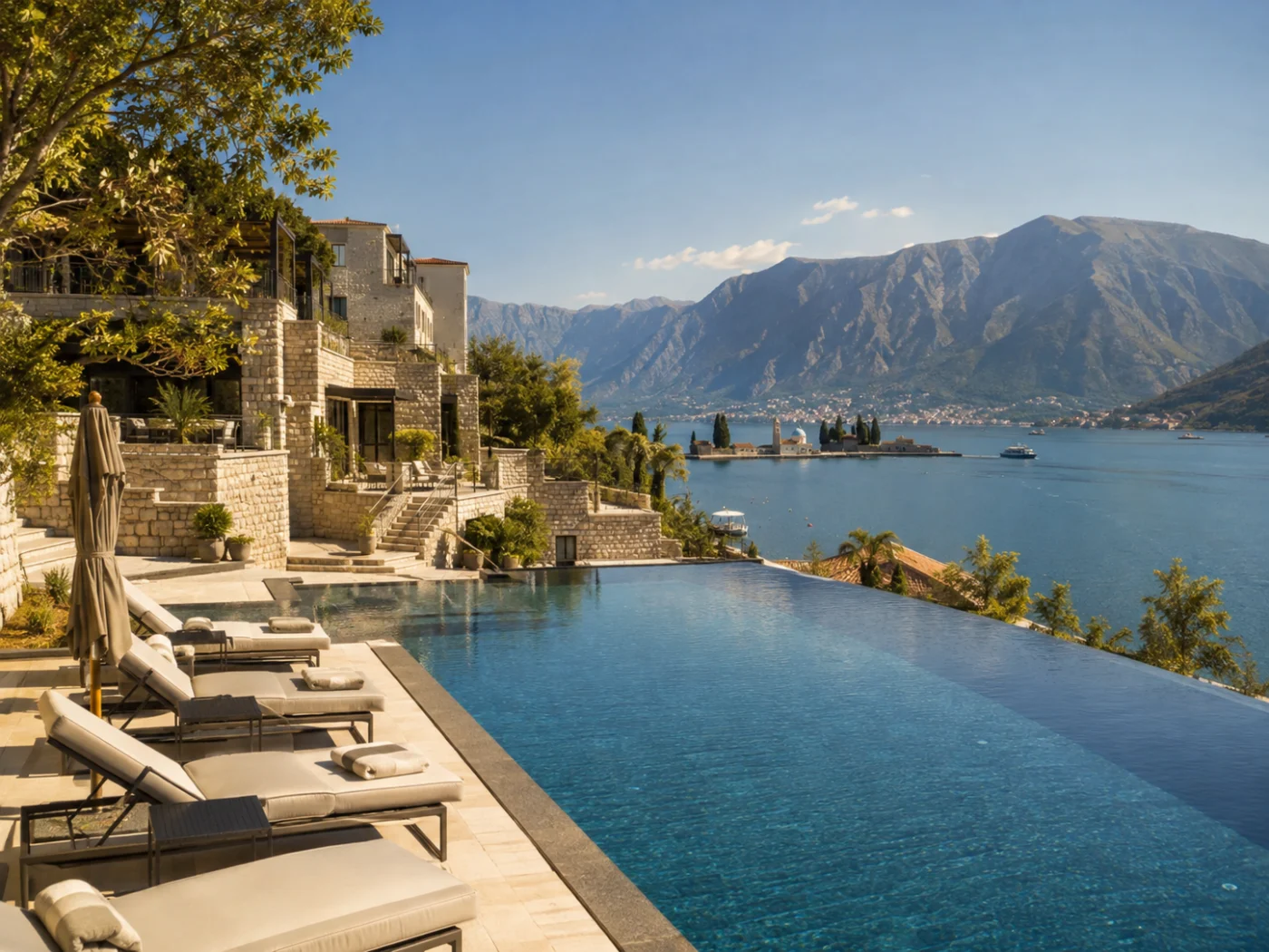Sunny terrace with infinity pool and sun loungers at an all-inclusive seaside resort, a destination for winter sun during the spring half-term